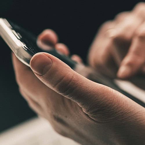 Man with cell phone in his hand and finger ready to dial