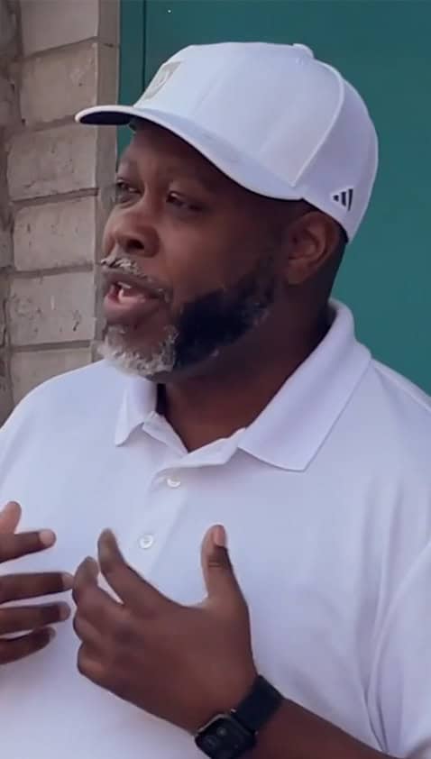 African American man with graying beard and white hat