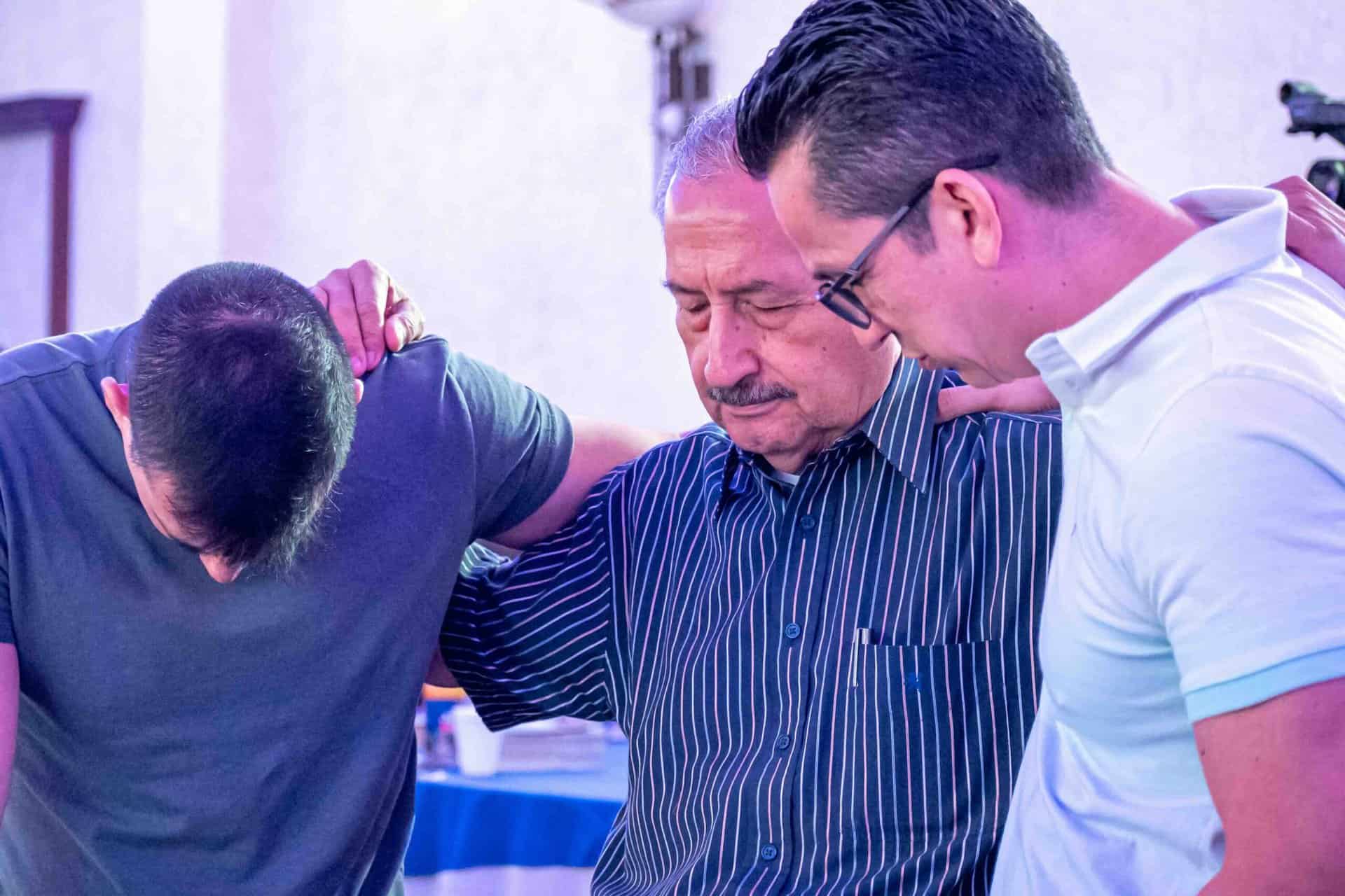 Hispanic men praying