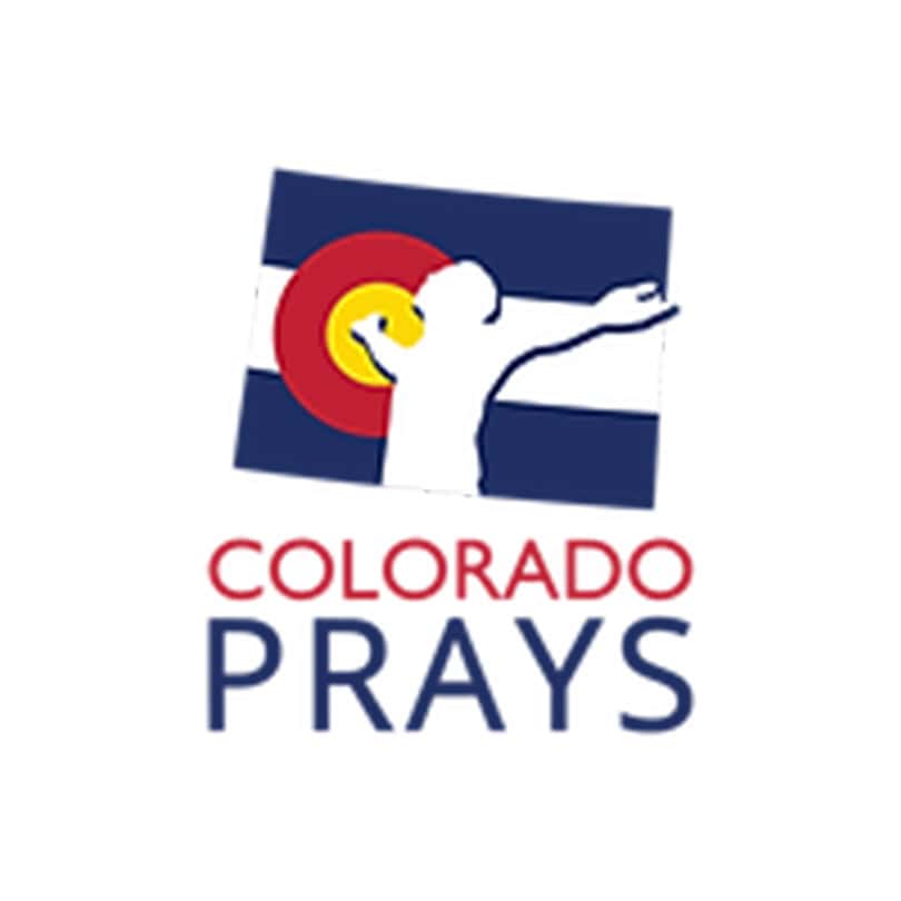 white silhouette of a man standing in front of a colorado state flag with arms wide open