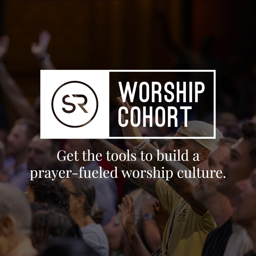 room full of people worshiping God with hands raised behind the logo for Strategic Renewal Worship Cohort