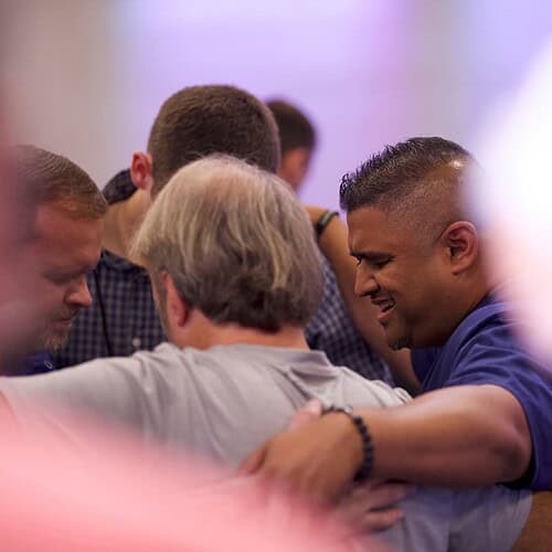 Pastors and church leaders praying together as they build a culture of prayer