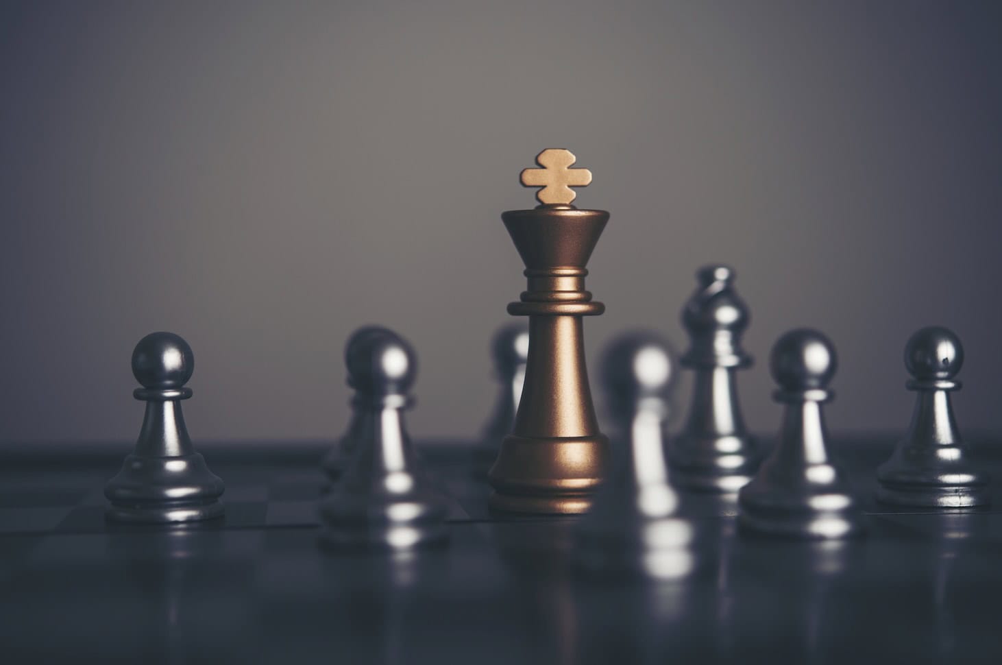 six chess pawns surrounding a golden king chess piece - symbolizing strategy, but with a biblical hint