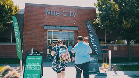 exterior of Mile City Church with family walking in front door