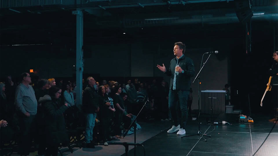 Travis Whittaker on stage at Mile City Church