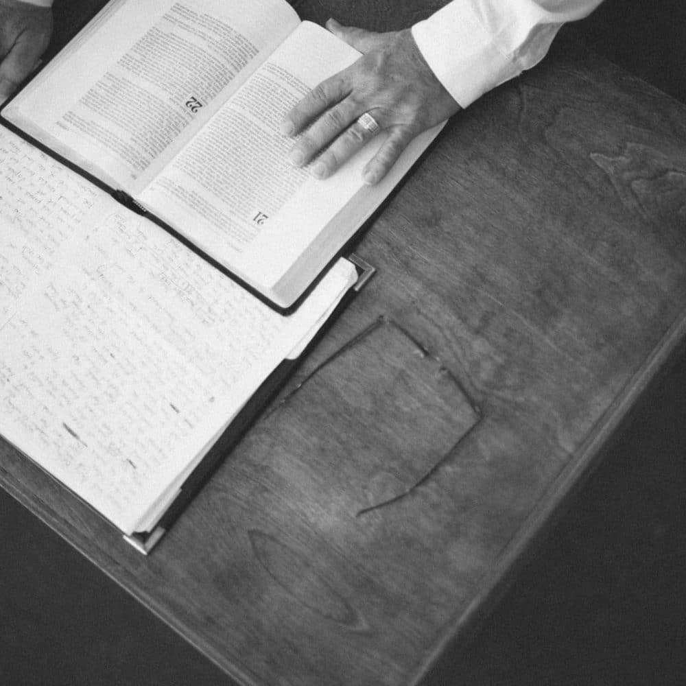 A pastor studies the Bible and takes notes.