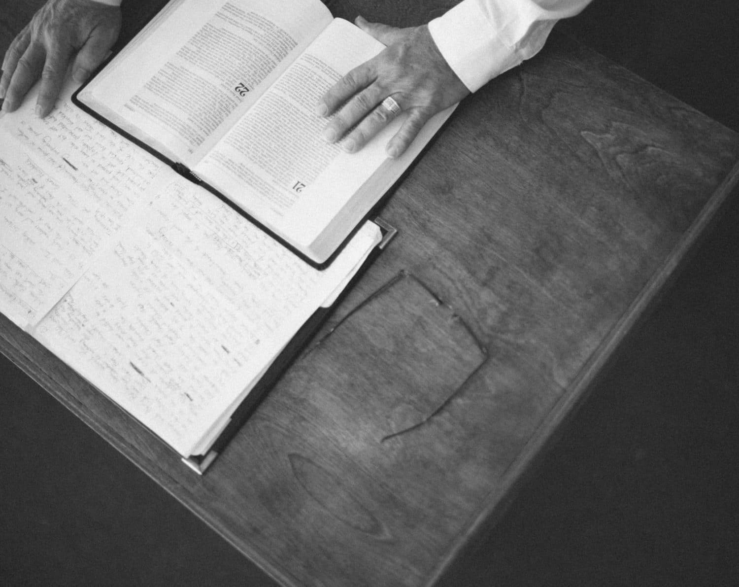 A pastor studies the Bible and takes notes.